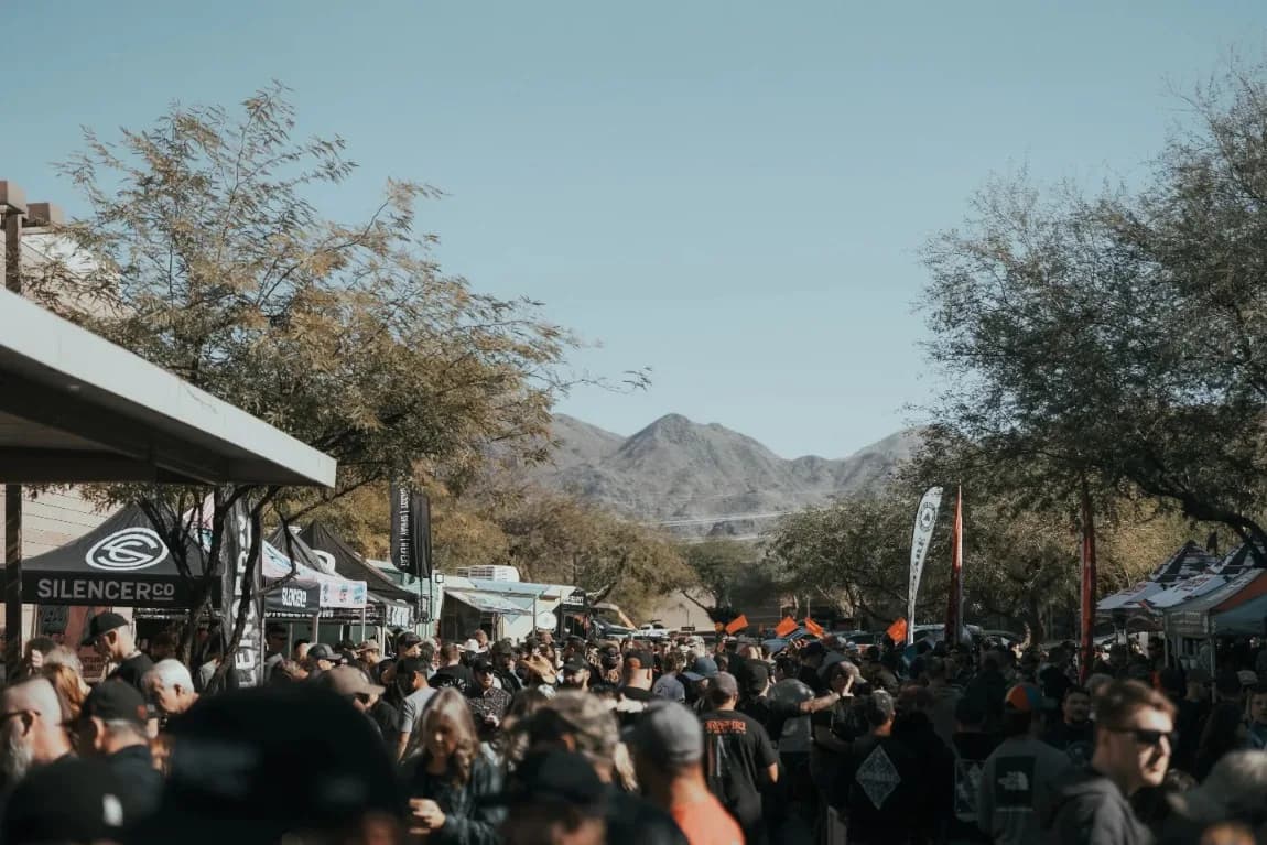 Crowd under vendor tents at a past event